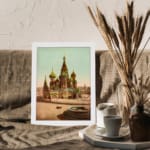 Vintage art print of Saint Basil’s Cathedral with colorful domes, a horse-drawn carriage, and a white frame displayed on the wall