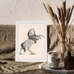 Black-and-white vintage sketch of a horse rearing with a snake wrapped around its body, framed in white. displayed on the wall