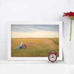Vintage wall art of two women sitting in an open field under a bright, cloudy sky with soft green and yellow tones. displayed on the wall