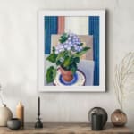Vintage wall art with potted purple flowers and terracotta pot on a blue and white plate, set against a soft geometric background. displayed on the wall