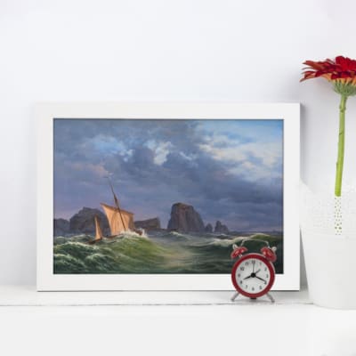 Vintage wall art featuring a stormy sea, sailboats, and rocky cliffs in deep blues, greens, and dramatic skies. displayed on the wall in a white frame
