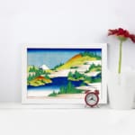 Infidu vintage wall art featuring a serene mountain lake with towering peaks, calm reflective waters, and surrounding trees. displayed on the wall art in a white frame