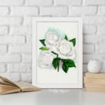 Vintage white rose wall art with green leaves and soft blue background. displayed on the wall
