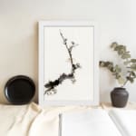 Minimal blossom branch vintage wall art in black and light brown on white background. displayed on the wall