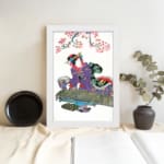 Vintage wall art of a Japanese woman in a purple kimono beneath cherry blossoms. displayed on the wall