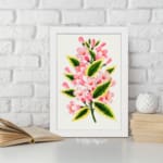Infidu vintage wall art with soft pink flowers and green leaves. displayed on the wall