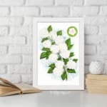 Infidu vintage wall art featuring delicate white flowers and vibrant green leaves against a white background displayed on the wall art in a white frame