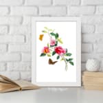 Vintage art of pink and red flowers with green leaves, two orange and brown butterflies, framed in white. displayed on the wall
