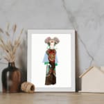 Vintage wall art of a person in traditional clothing with colorful robe and detailed headpiece, framed in white. displayed on the wall
