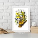 Vintage wall art showing two black and white birds flying near a tree branch with green leaves and bright yellow flowers on a white background. displayed on the wall