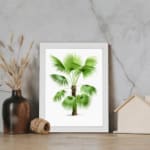 Infidu vintage wall art featuring a small palm tree with green fan-shaped leaves and a textured brown trunk. displayed on the wall