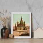 Vintage art print of Saint Basil’s Cathedral with colorful domes, a horse-drawn carriage, and a white frame displayed on the wall
