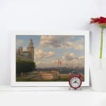 Vintage wall art of a coastal town with sailing ships, historic buildings, and soft blue sky by Infidu. displayed on the wall