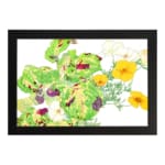 Vintage floral wall art with yellow flowers, green leaves, and a black frame on a white background. hung on the wall