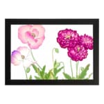Vintage floral wall art featuring pink and purple flowers with green leaves, set against a white background with a black frame. hung on the wall