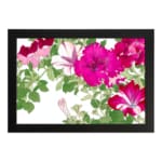 Infidu Vintage Floral Wall Art with pink and red flowers, green leaves, a white background, and a black frame for an elegant and timeless look. hung on the wall