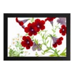 Vintage floral wall art with red and purple trumpet flowers, green leaves, and a black frame on a white background. hung on the wall