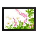 Vintage floral wall art with delicate pink and white flowers, green leaves, and a black frame on a white background. hung on the wall