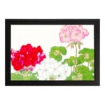 Infidu Vintage Floral Wall Art with red, white, and pink flowers, green leaves, and a black frame on a white background. hung on the wall