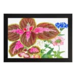 Vintage wall art featuring brown leaves with pink patterns and delicate blue, pink, and white flowers on a white background, framed in black. hung on the wall