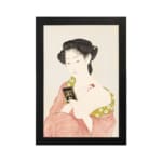 Vintage Japanese wall art featuring a woman in traditional dress holding a book with soft red and green patterns. hung on the wall