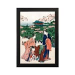 Vintage Japanese wall art of women in kimonos under cherry blossom trees with a temple in the background. hung on the wall