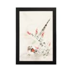 Vintage wall art with a bird surrounded by delicate flowers and plants in soft greens, reds, and whites, framed in black. hung on the wall