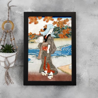 Vintage Japanese wall art with a woman in a kimono near a river, detailed autumn leaves, and a serene landscape in classic Ukiyo-e style. displayed on the wall