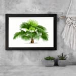 Vintage wall art with a green palm plant, detailed leaves, a white background, and a black frame for a classic and elegant look. displayed on the wall