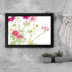 Infidu Vintage Floral Wall Art with pink, white & red flowers, green leaves, and a black frame on a white background. displayed on the wall