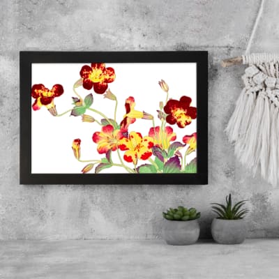 Vintage floral wall art with red, yellow, and orange flowers, green leaves, and a black frame on a white background. displayed on the wall