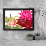 Vintage floral wall art featuring pink, red, and yellow lotus flowers with green leaves on a white background, framed in black. display on the wall
