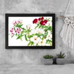 Infidu Vintage Floral Wall Art with white, pink, and red flowers, green leaves, and a black frame on a white background. displayed on the wall