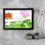 Infidu Vintage Floral Wall Art with orange, pink, and white flowers, green leaves, and a black frame on a white background. displayed on the wall