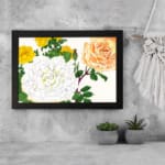Infidu Vintage Floral Wall Art with yellow, orange, and white roses, green leaves, and a black frame on a white background. displayed on the wall