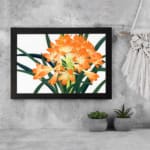 Infidu Vintage Floral Wall Art with bright orange flowers, yellow centers, dark green leaves, and a black frame on a white background. displayed on the wall