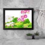 Vintage floral wall art featuring pink and white flowers with green leaves on a white background, framed in black for a stylish and elegant look. displayed on the wall