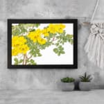 Infidu Vintage Floral Wall Art with yellow flowers, green leaves, and a black frame on a white background, adding a classic botanical touch. displayed on the wall.