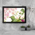 Infidu vintage orchid wall art with pink and white orchids and green leaves, framed in black for an elegant, timeless look. displayed on the wall