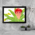 Infidu Vintage Botanical Wall Art with red, orange, and yellow flowers, green leaves, and a black frame on a white background. displayed on the wall