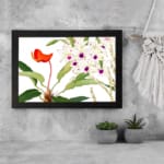 Infidu Vintage Floral Wall Art with white flowers, purple centers, and an orange flower, set against a white background with green leaves. displayed on the wall in a black frame
