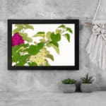 Infidu Vintage Floral Wall Art with pink and yellow flowers, green leaves, and a white background, framed in black for a stylish look. displayed on the wall