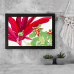Infidu Vintage Floral Wall Art with large red leaves, green leaves with red accents, and a black frame on a white background. displayed on the wall.
