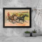 Vintage horse racing wall art with jockeys riding on a dirt track, surrounded by a countryside landscape with a farmhouse, framed in black. displayed on the wall