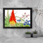 Infidu Vintage Botanical Wall Art with red, yellow, pink, and blue flowers, green leaves, and white background, creating a fresh and elegant look. displayed on the wall in a black frame