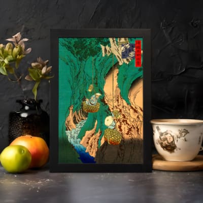 Vintage Asian-style mountain wall art with bold green hills, waterfalls, trees, and traditional red stamp. displayed on the wall in a black frame