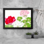 Infidu Vintage Floral Wall Art with red, white, and pink flowers, green leaves, and a black frame on a white background. displayed on the wall
