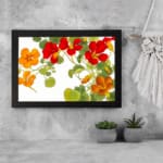 Infidu vintage floral wall art with red and orange flowers, green leaves, and a black frame on a white background. displayed on the wall