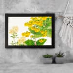 Infidu vintage wall art with bright yellow and pale yellow flowers, green leaves, and a black frame on a white background for an elegant look. displayed on the wall art in a black frame