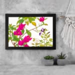 Infidu vintage wall art with bright pink, purple, and white flowers, green leaves, and a black frame on a white background for a classic look. displayed on the wall art in a black frame